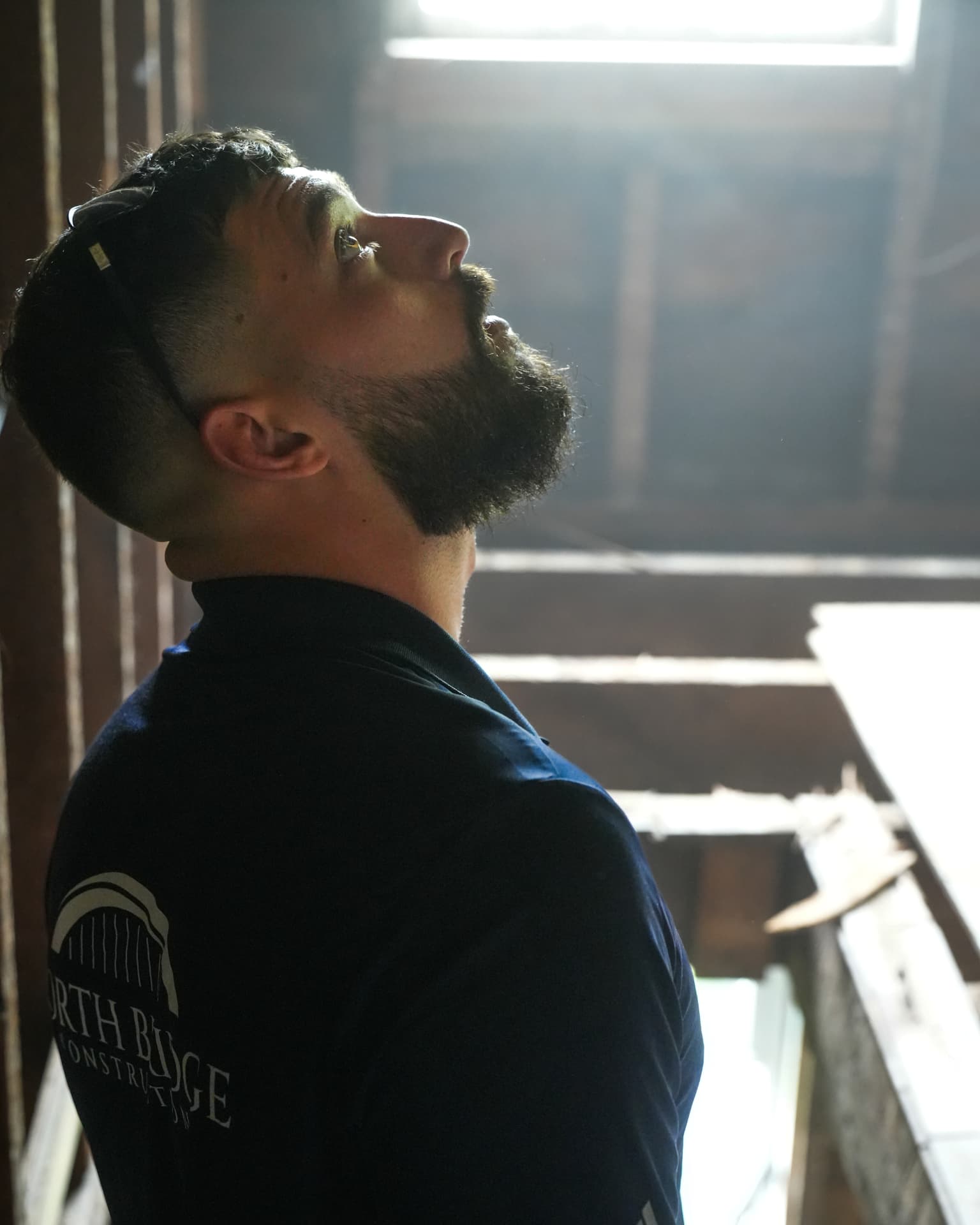 North Bridge crew member checking ceiling framing on a job site